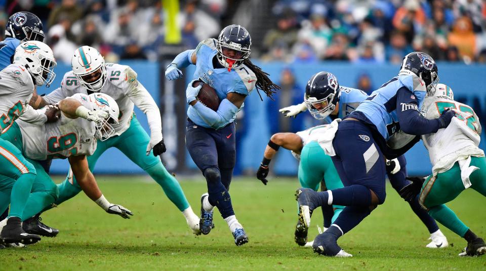 Titans running back D'Onta Freeman, picks up some of 132 yards against another big hole in Miami's defense.