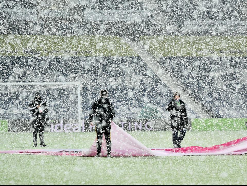 <p>Ground staff clear snow from the pitch prior to the Premier League match at The Hawthorns, West Bromwich.</p>PA