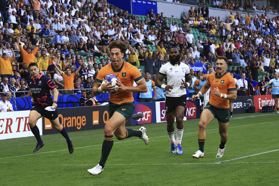 Australia's Mark Nawaqanitawase runs to score a try during the Rugby World Cup Pool C match between Australia and Fiji at the Stade Geoffroy Guichard in Saint-Etienne, France, Sunday, Sept. 17, 2023. (AP Photo/Aurelien Morissard)