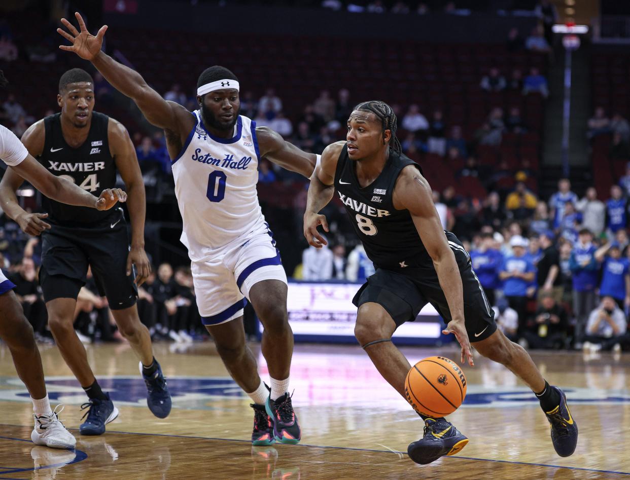 Feb 14, 2024; Newark, New Jersey, USA; Xavier Musketeers guard Quincy Olivari (8) dribbles against Seton Hall Pirates guard Dylan Addae-Wusu (0) during the first half at Prudential Center.