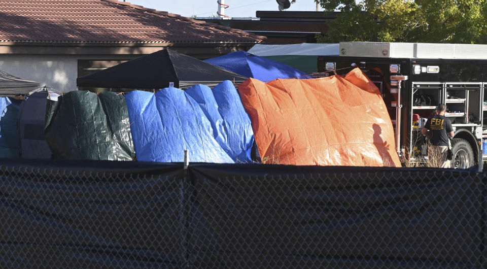 Privacy fences are set up on the perimeter of the Return to Nature Funeral Home on Monday, Oct. 9, 2023, where over 100 decomposing bodies were found last week in Penrose, Colo. (Jerilee Bennett/The Gazette via AP)