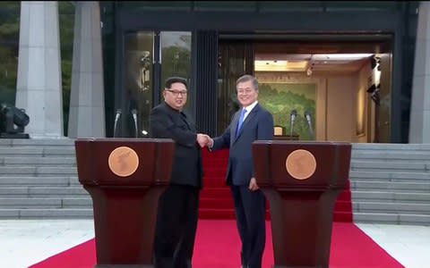 South Korean President Moon Jae-in and North Korean leader Kim Jong Un shake hands after delivering a joint statement during the inter-Korean summit at the truce village of Panmunjom - Credit: Reuters