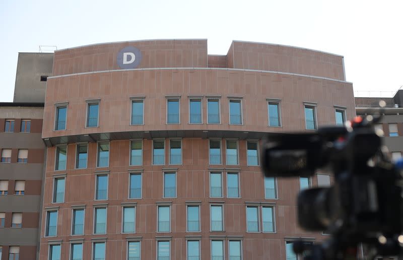 Media gather outside the San Raffaele hospital after Italy's former prime minister Silvio Berlusconi has been hospitalised for further checks after testing positive for the coronavirus disease (COVID-19), in Milan