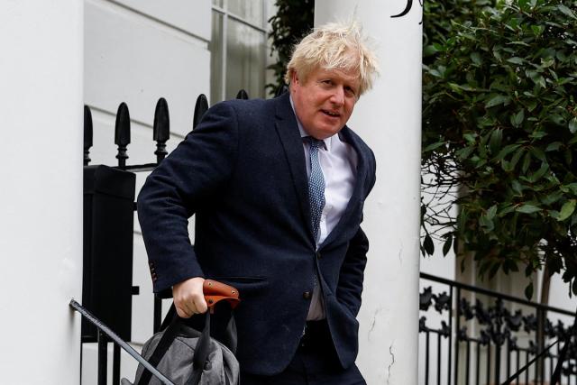 Boris Johnson outside his home on Tuesday (REUTERS)
