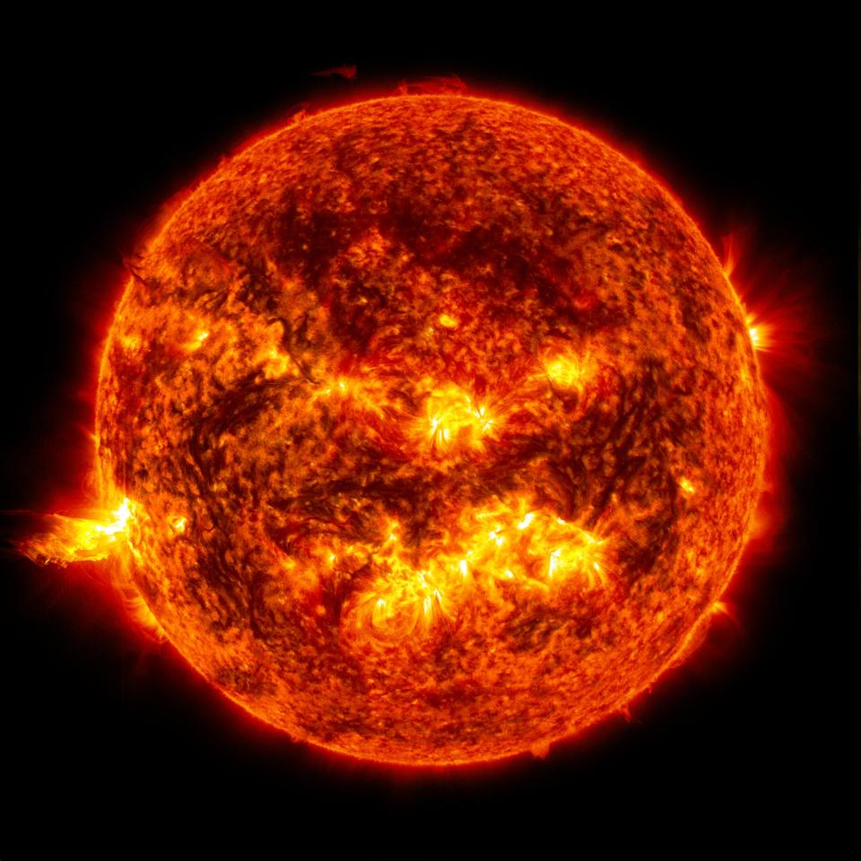 A solar flare on the left side of the Sun and an eruption of solar material shooting through the sun’s atmosphere (Nasa/Goddard/SDO)