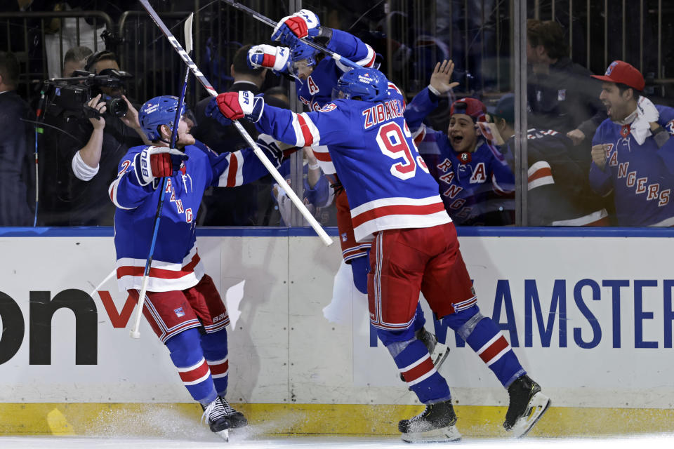 New York Rangers left wing Artemi Panarin (10) reacts with teammates after scoring the game winning goal against the Pittsburgh Penguins during overtime in Game 7 of an NHL hockey Stanley Cup first-round playoff series Sunday, May 15, 2022, in New York. The Rangers won 4-3 in overtime. (AP Photo/Adam Hunger)