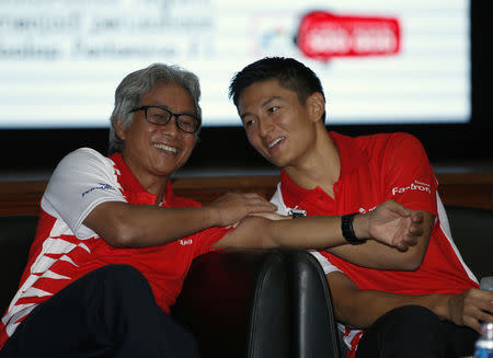 Rio Haryanto (R), Indonesia's first Formula One driver, sits with Dwi Soetjipto (L), CEO of Indonesia's state energy company Pertamina and sponsor at an event announcing his signing with Manor Racing at Pertamina headquarters in Jakarta, Indonesia February 18, 2016. The 23-year-old Haryanto will make his race debut in Australia when the season starts on March 20.REUTERS/Darren Whiteside