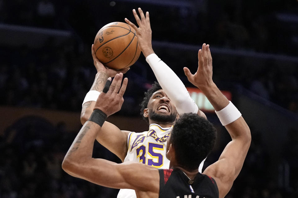 Los Angeles Lakers forward Christian Wood, top, shoots as Portland Trail Blazers forward Toumani Camara defends during the first half of an NBA basketball game Sunday, Nov. 12, 2023, in Los Angeles. (AP Photo/Mark J. Terrill)