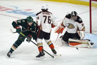 Minnesota Wild's Marcus Foligno (17) reaches for a rebound past Anaheim Ducks' Josh Mahura (76) after Ducks goalie John Gibson, right, stopped a shot during the first period of an NHL hockey game Saturday, Oct. 23, 2021, in St. Paul, Minn. (AP Photo/Jim Mone)