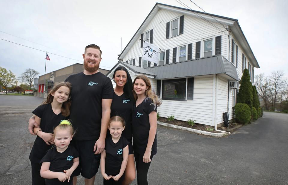 The Stone family, new owners of the historic Stone's Pub at 3115 East Henrietta Road in Henrietta Friday, May 6, 2022.  Pictured clockwise from top left are Tyler Stone and wife Ashley Stone, and their children Elliana, 11, Nova, 5, Breezie, 3, and Olivia, 10.
