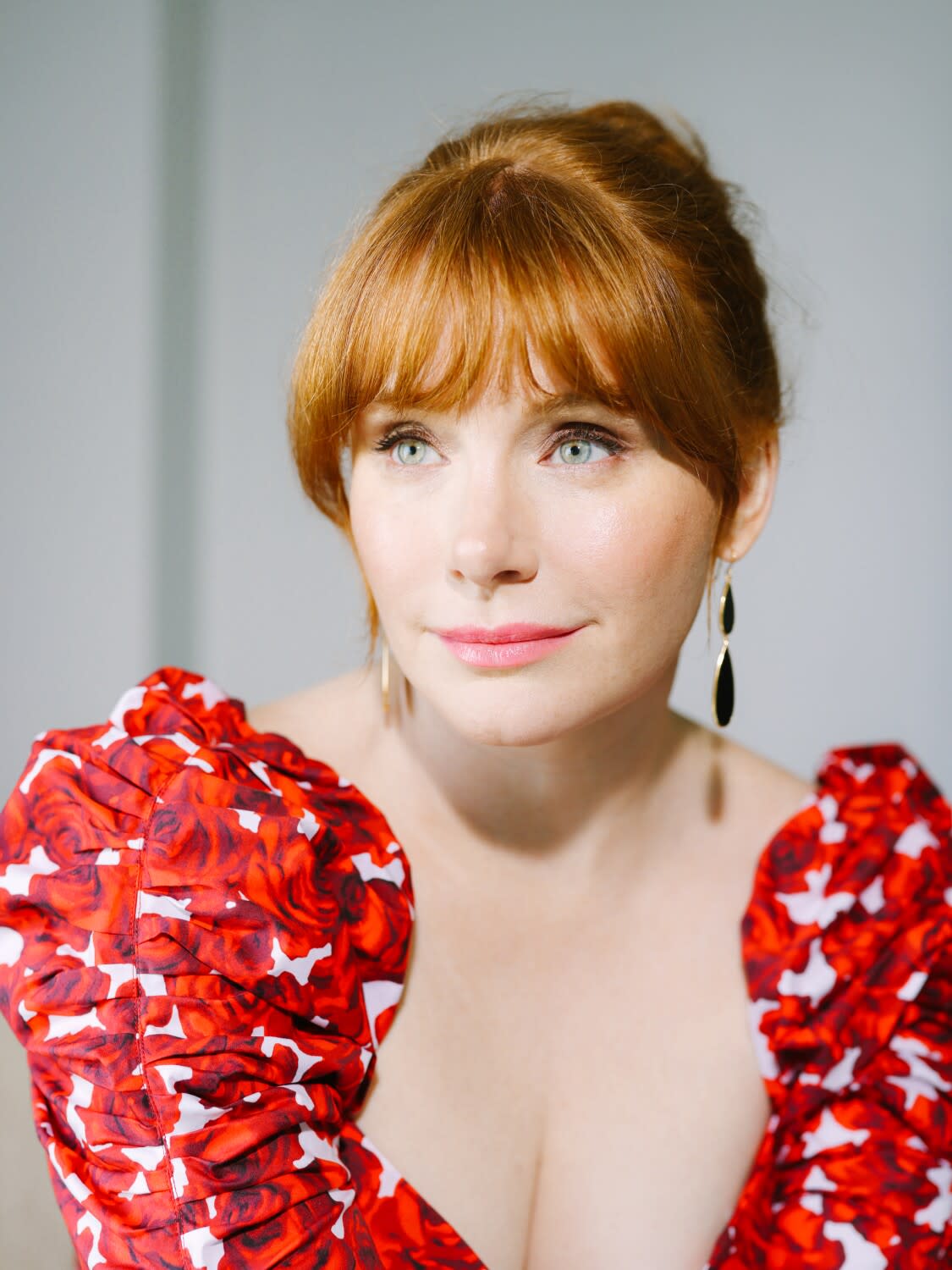 A woman in a red dress poses for a photo