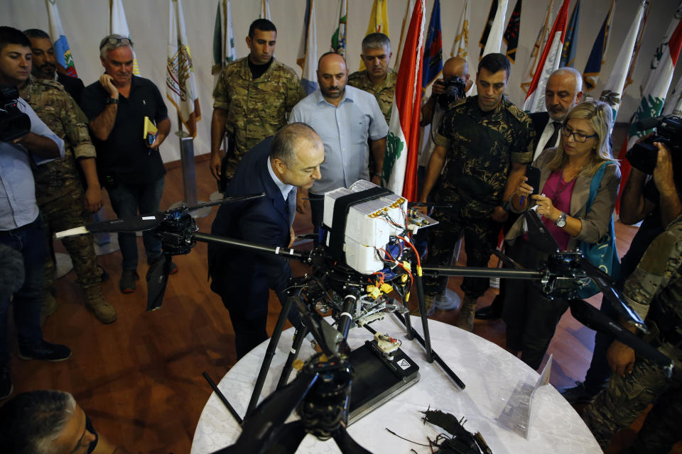 Lebanese Defense Minister Elias Bou Saab, center, points to parts of an Israeli drone that crashed in southern Beirut last month during a press conference to announce the results of an investigation into the incident, at the Lebanese Defense Ministry, in Yarzeh near Beirut, Lebanon, Thursday, Sept. 19, 2019. The investigation has concluded that two Israeli drones that crashed in the Lebanese capital last month were on an attack mission, one of them armed with 4.5 kilograms of explosives. (AP Photo/Bilal Hussein)