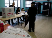 A man arrives to vote at a polling station in Rome, Sunday, May 26, 2019. Pivotal elections for the European Union parliament reach their climax Sunday as the last 21 nations go to the polls and results are announced in a vote that boils down to a continent-wide battle between euroskeptic populists and proponents of closer EU unity. (AP Photo/Alessandra Tarantino)