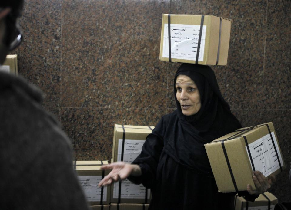 An Egyptian worker carries boxes of ballots at the Giza courthouse, in Cairo, Egypt, Monday, Jan. 13, 2014. The January 14-15 vote on the draft constitution will be the first real test of the post-Morsi regime. A comfortable "yes" vote and a respectable turnout would be seen as bestowing legitimacy, while undermining the Islamists' argument that Morsi remains the nation's elected president. (AP Photo/Amr Nabil)