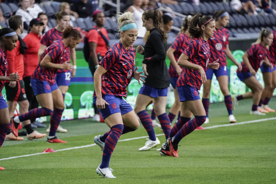 U.S. midfielder Julie Ertz, center, warms up for the team's international friendly soccer match against South Africa, Thursday, Sept. 21, 2023, in Cincinnati. (AP Photo/Joshua A. Bickel)