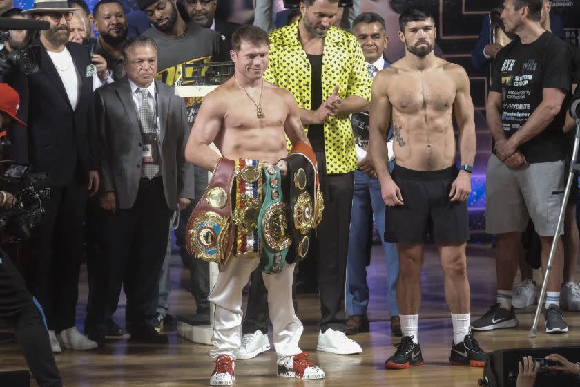 Boxers Saul "Canelo" Alvarez of Mexico, left, and John Ryder of Britain, pose for photos during their weigh-in ceremony in Guadalajara, Mexico, Friday, May 5, 2023. Alvarez and Ryder will meet for a super middleweight championship fight at Akron Stadium on May 6. (AP Photo/Refugio Ruiz)