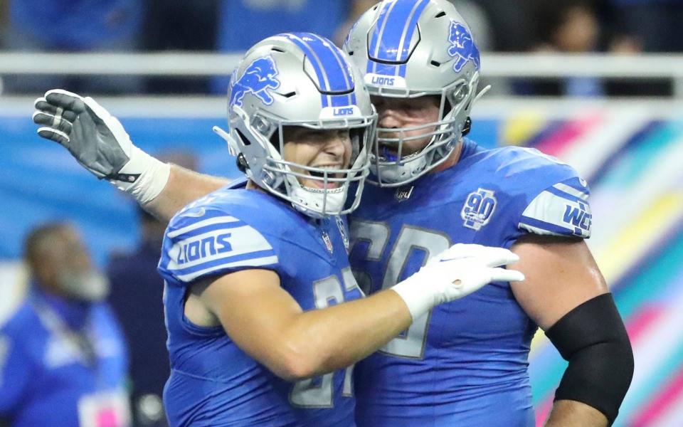Detroit Lions tight end Sam LaPorta (87) celebrates his touchdown with guard Graham Glasgow (60) during first-half action at Ford Field in Detroit on Sunday, Oct, 8, 2023.