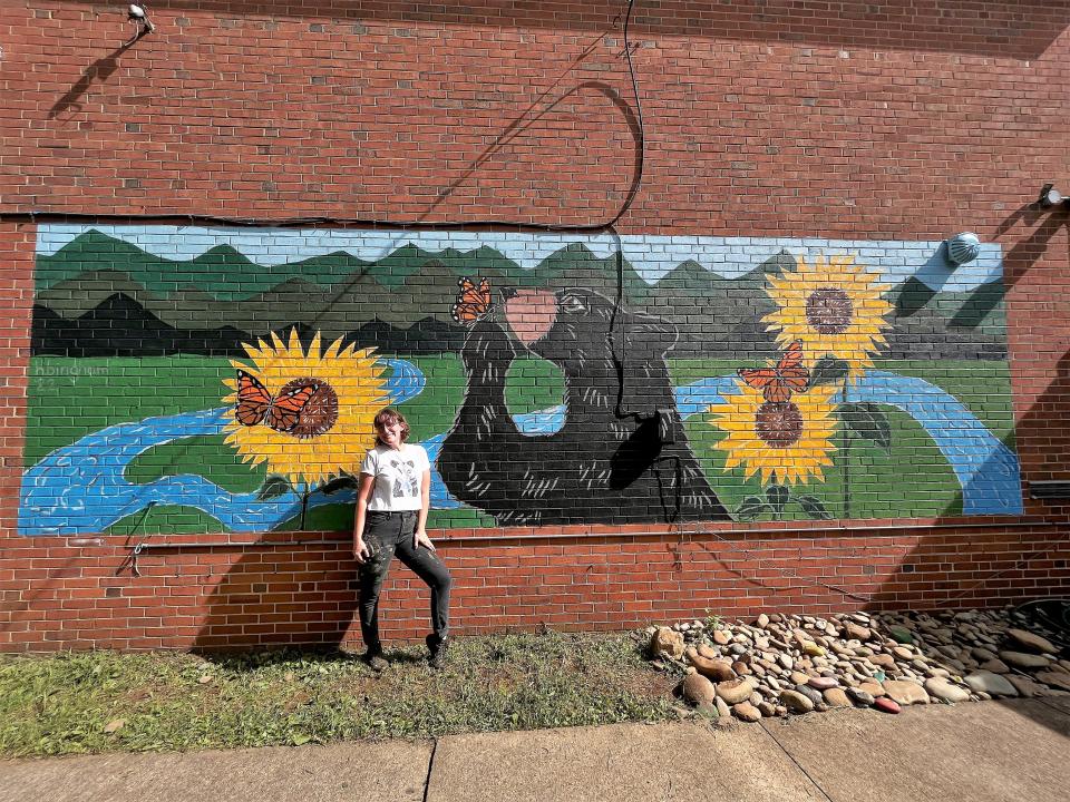 Hannah Bingham in front of her completed mural at South Knoxville Elementary School on Aug. 4, 2022.