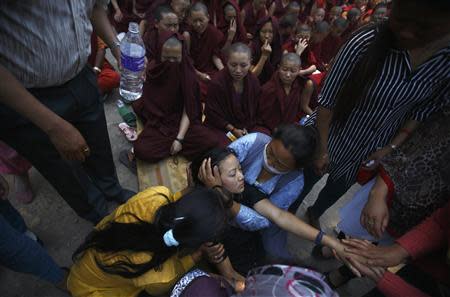 Family members comfort the daughter of Ankaji Sherpa, who lost his life in an avalanche at Mount Everest last Friday, during the cremation ceremony of Nepali Sherpa climbers in Kathmandu April 21, 2014. REUTERS/Navesh Chitrakar