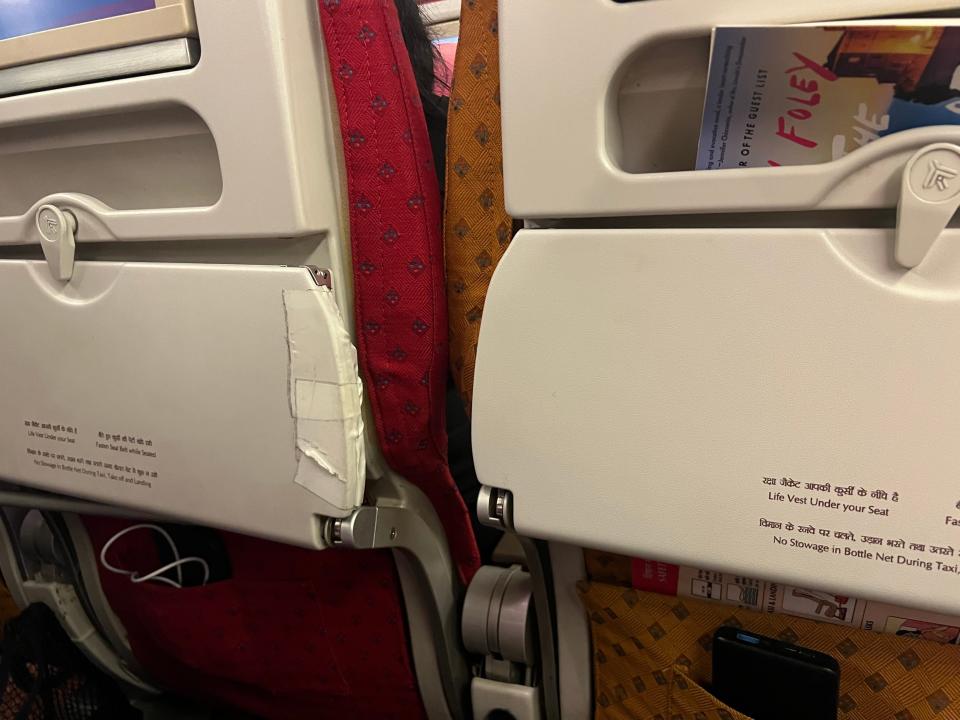 Tape on the tray tables on Air India's economy seat.