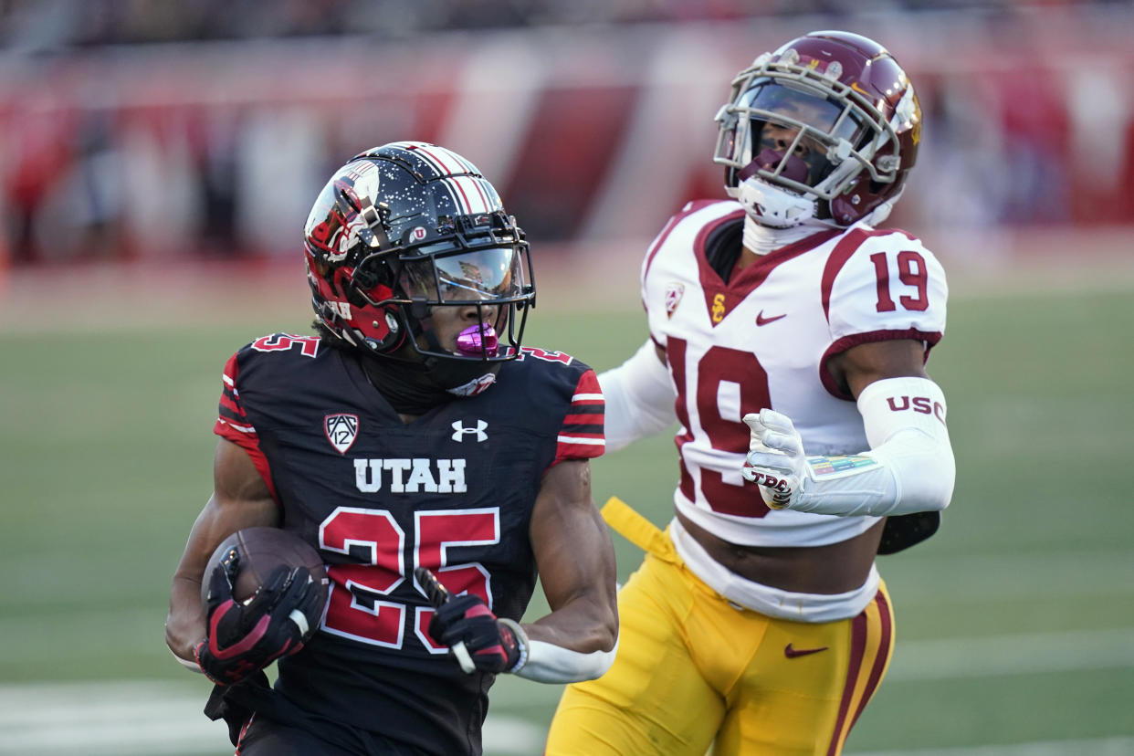 Utah wide receiver Jaylen Dixon (25) carries the ball past USC defensive back Jaylin Smith (19) during the first half of an NCAA college football game Saturday, Oct. 15, 2022, in Salt Lake City. (AP Photo/Rick Bowmer)