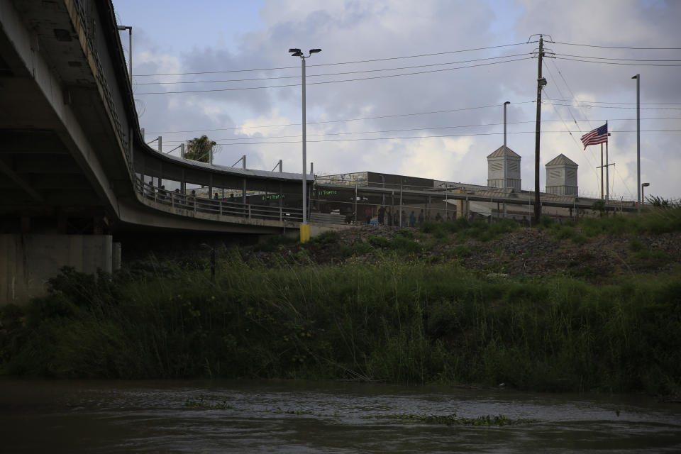 Pedestrian commuters wait in line to enter Brownsville, Texas, on the Puerta Mexico bridge across the Rio Grande, seen from downtown Matamoros, Tamaulipas state, Mexico, Wednesday, June 26, 2019. Hundreds of migrants, some who have been in line for months, are awaiting their turn on the Mexican side to request asylum in the U.S. (AP Photo/Rebecca Blackwell)