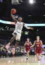 Georgia Tech guard Asanti Price soars to the basket past Elon defenders Simon Wright, center, and Zac Ervin, right, during the second half of an NCAA college basketball game on Monday, Nov. 11, 2019, in Atlanta. Georgia Tech won, 64-41. (Curtis Compton/Atlanta Journal-Constitution via AP)