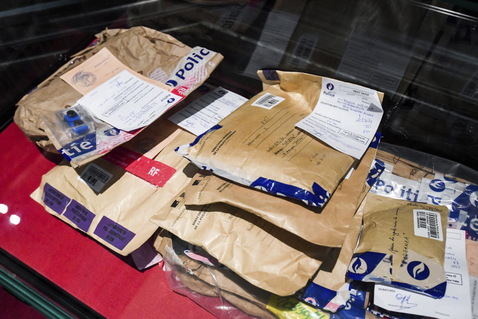Bags of evidence are presented on a table at the trial of Mehdi Nemmouche at the Justice Palace in Brussels, Tuesday, Jan. 15, 2019. Mehdi Nemmouche is accused of shooting dead four people at a Jewish museum in Belgium in 2014. (Frederic Sierakowski, Pool Photo via AP)