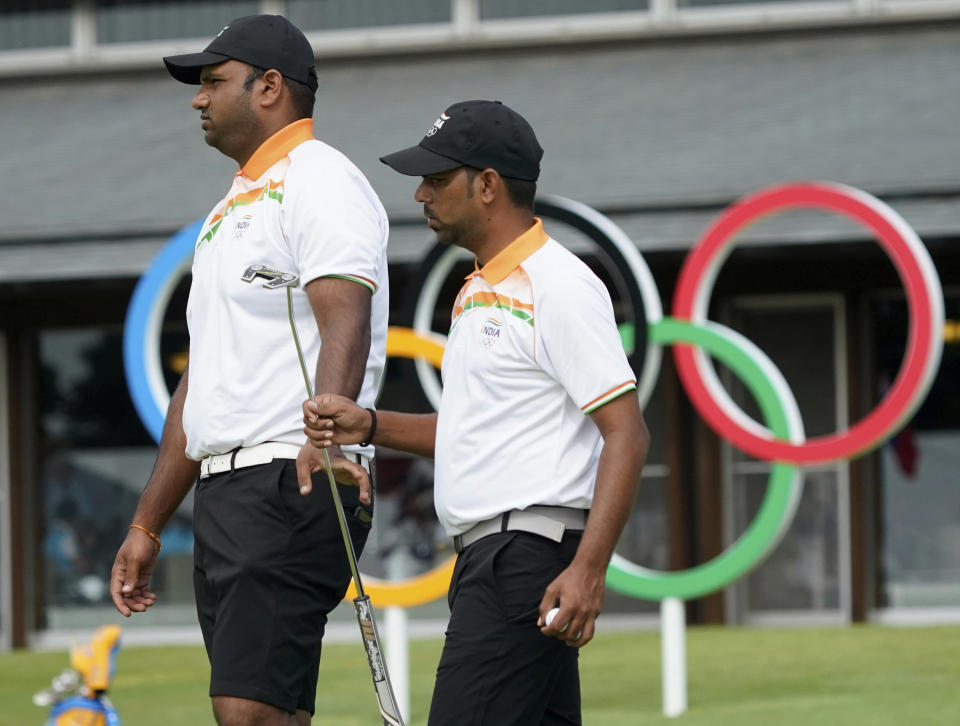 India's Udayan Mane, left, and his teammate Anirban Lahiri at the putting green during a practice session of the men's golf event at the 2020 Summer Olympics, Tuesday, July 27, 2021, at the Kasumigaseki Country Club in Kawagoe, Japan, (AP Photo/Matt York)