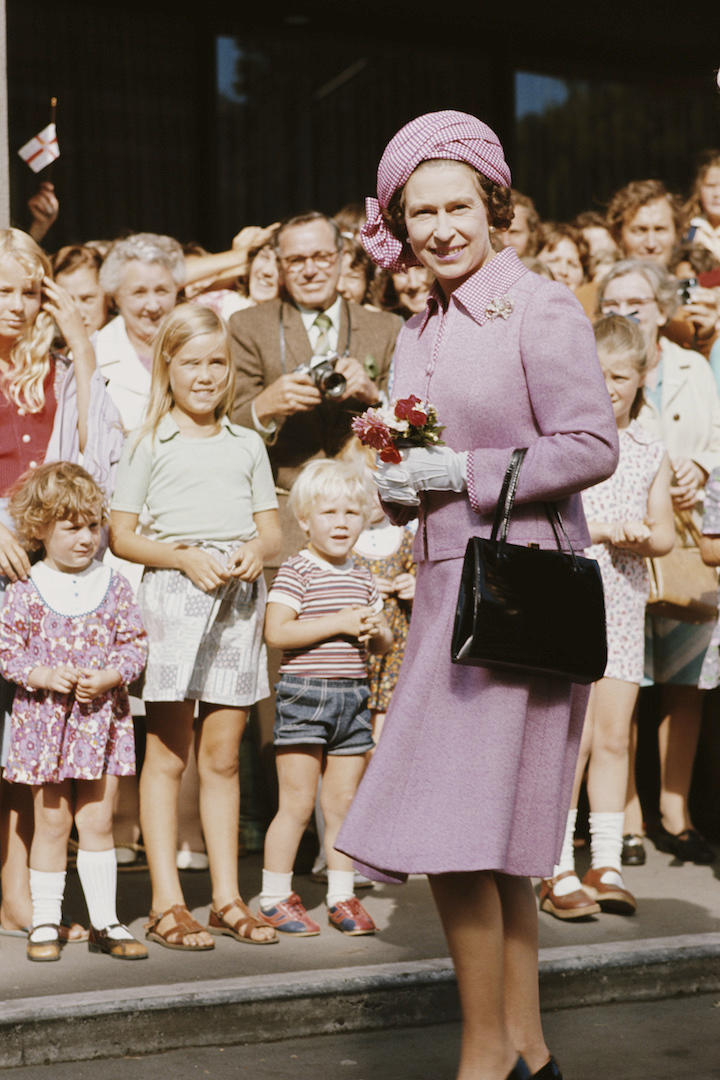 Queen Elizabeth II visited Christchurch during her visit to New Zealand in 1977 and greeted well-wishers in a powder pink skirt suit complete with a matching hat. <em>[Photo: Getty]</em>