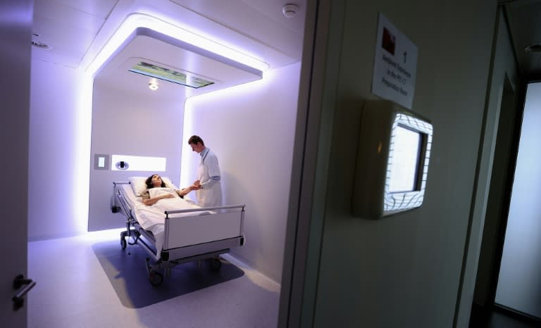 A doctor stands next to a patient at the Dutch Royal Philips Electronics Hospital research facility, at its Eindhoven-based Research Laboratories