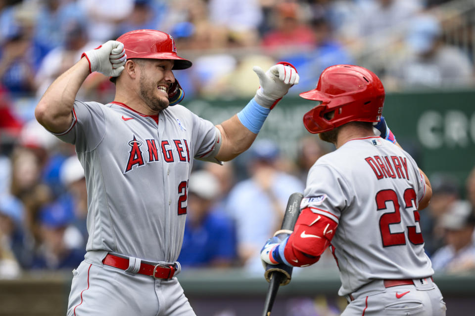 Los Angeles Angels' Mike Trout, left, celebrates his home run against the Kansas City Royals with teammate Brandon Drury (23) during the fifth inning of a baseball game, Sunday, June, 18, 2023 in Kansas City, Mo. (AP Photo/Reed Hoffmann)
