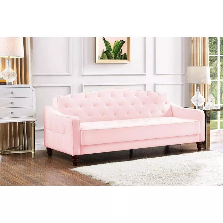 the tufted sofa with slightly sloped arms
