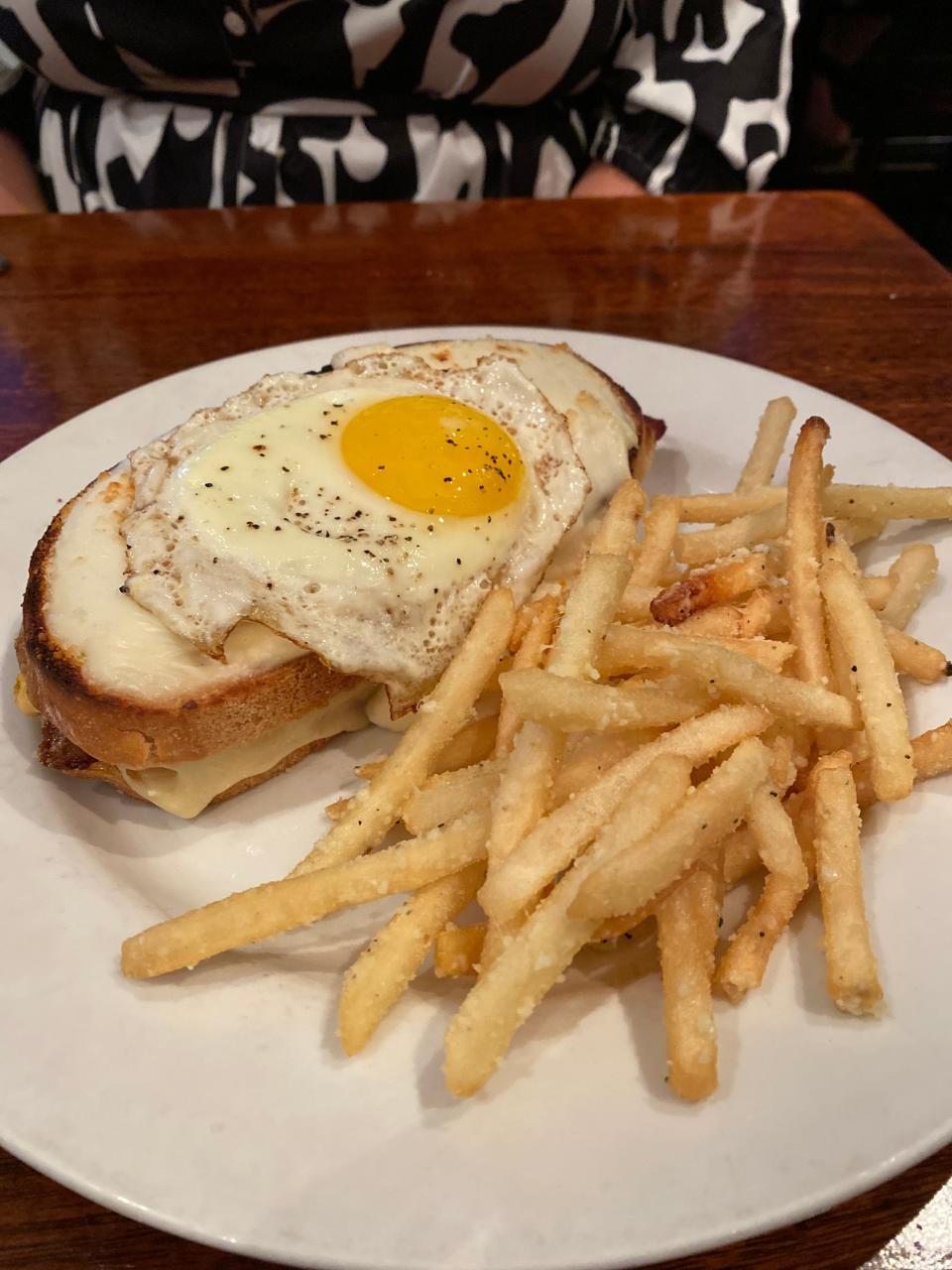 The Grilled Cheese "Deluxe" at The Majestic Grille. This weekend brunch dish is a grilled cheese stuffed with cheddar cheese, bacon, tomato and Creole mustard that is topped with béchamel sauce and a sunny side egg.
