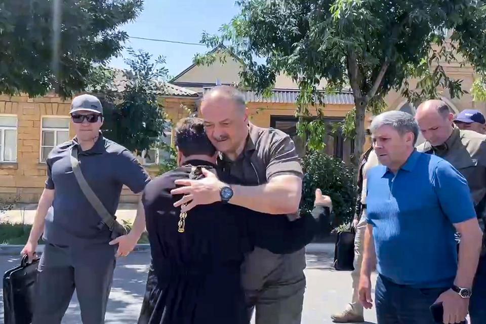 A photo taken from video posted on the Telegram channel of the head of the Dagestan Republic of Russia on June 24, 2024 shows Dagestan's top official Sergei Melikov, center, greeting a priest as he visits the Orthodox Church of the Intercession of the Blessed Virgin Mary in Derbent after a counter-terrorist operation in republic of Dagestan, Russia. / Credit: National Antiterrorism Committee via AP