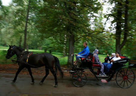 Tourists from the Middle East are driven in horse carriages at Vrelo Bosne nature park in Ilidza near Sarajevo, Bosnia and Herzegovina, August 19, 2016. Picture taken August 19, 2016. REUTERS/Dado Ruvic