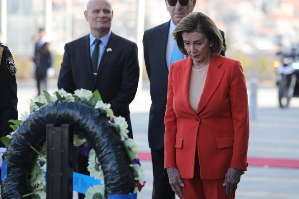 U.S. House Speaker Nancy Pelosi, right, lays a wreath during an official welcome ceremony at the Knesset , the Israeli Parliament in Jerusalem Wednesday, Feb. 16, 2022. (Abir Sultan/Pool Photo via AP)