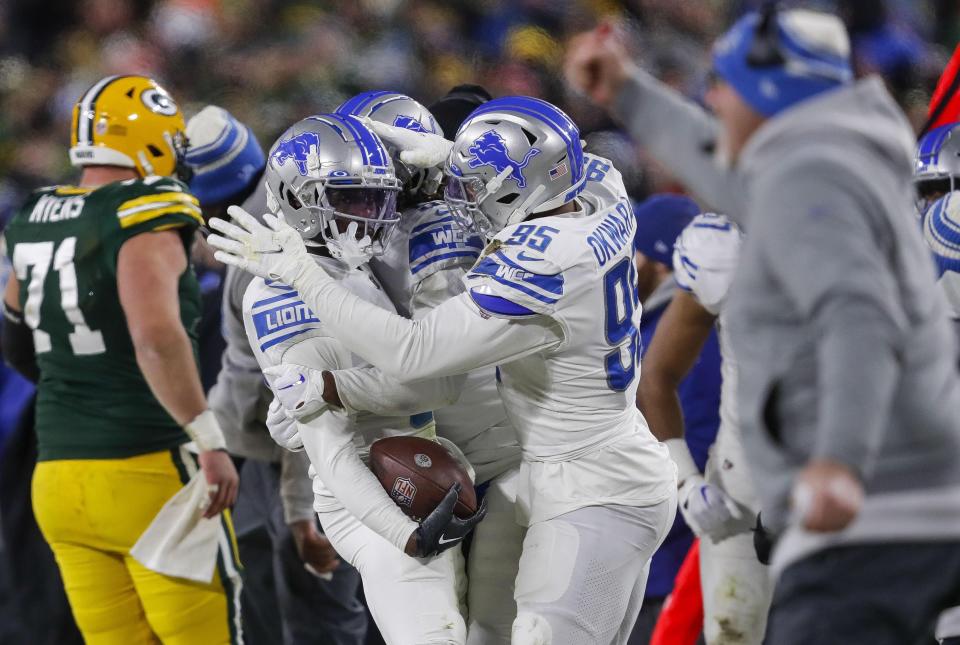 Detroit Lions safety Kerby Joseph (left) celebrates with Detroit Lions linebacker Romeo Okwara (95) after intercepting a pass against the Green Bay Packers on Sunday, January 8, 2023, at Lambeau Field in Green Bay, Wis. Tork Mason/USA TODAY NETWORK-Wisconsin 