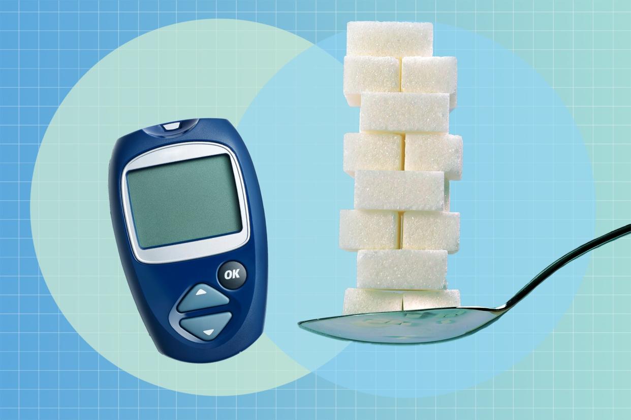 a glucose monitor and a spoon holding a stack of sugar cubes