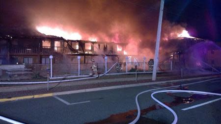 Firefighters battle flames in the early morning at a Jersey Shore motel in this March 21, 2014 handout photo. REUTERS/Office of the Ocean County Prosecutor/Handout via Reuters