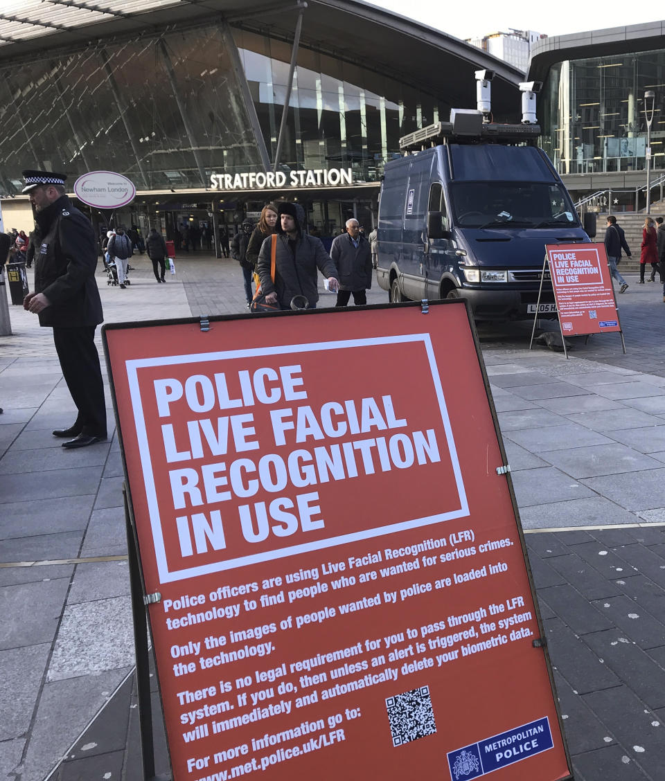 A mobile police facial recognition facility outside a shopping centre in London Tuesday Feb. 11, 2020, “We don't accept this. This isn't what you do in a democracy," said Silkie Carlo, director of privacy campaign group Big Brother Watch, who are demonstrating against the surveillance. London police started using facial recognition surveillance cameras mounted on a blue police van on Tuesday to automatically scan for wanted people, as authorities adopt the controversial technology that has raised concerns about increased surveillance and erosion of privacy. (AP Photo/Kelvin Chan)