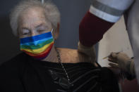 An Israeli man receives his second Pfizer-BioNTech COVID-19 vaccine from a Magen David Adom national emergency service volunteer, at a private nursing home, in Netanya, Israel, during a nationwide lockdown to curb the spread of the virus, Tuesday, Jan. 19, 2021. (AP Photo/Oded Balilty)