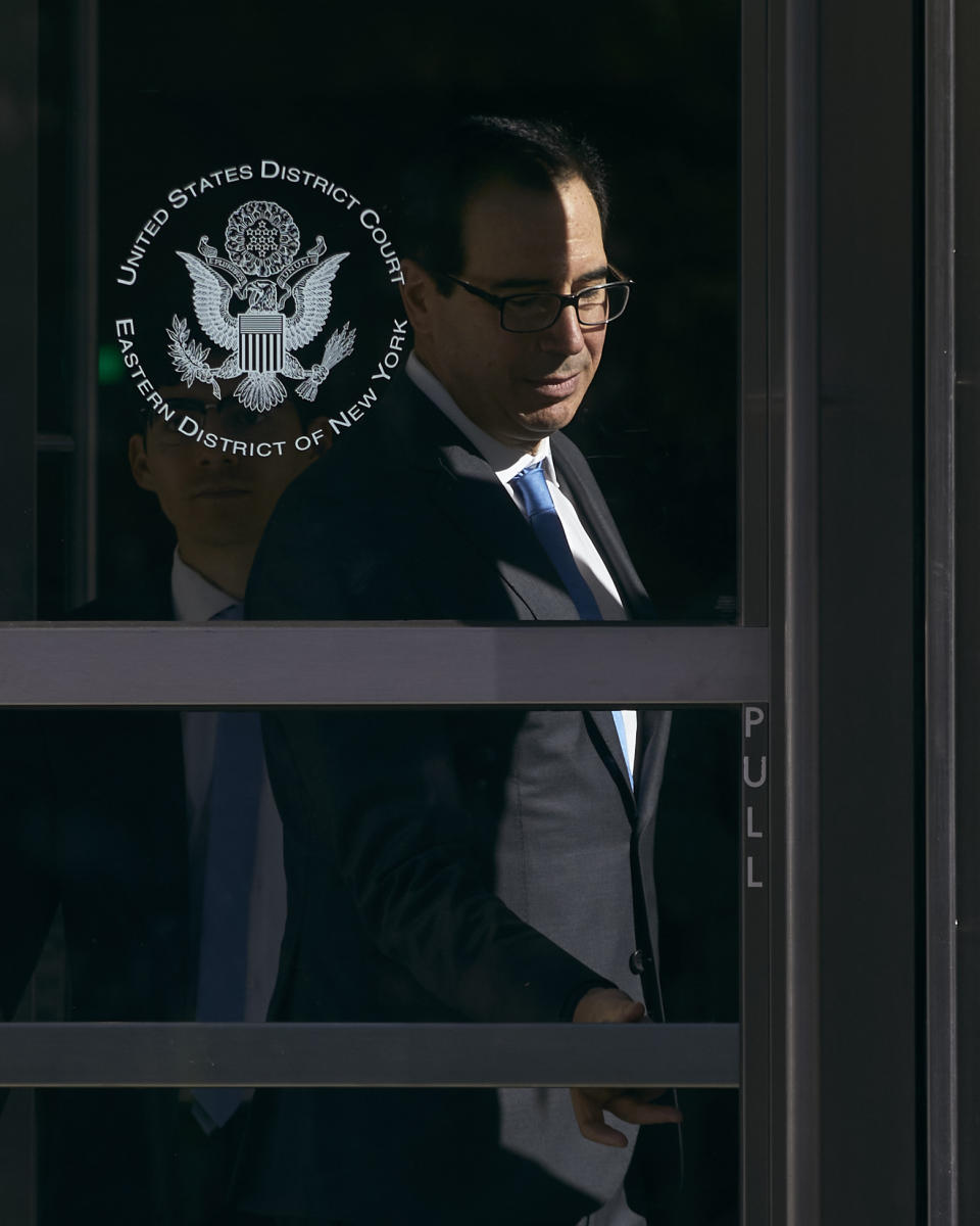 Former United States Secretary of the Treasury, Steven Mnuchin, center, leaves the Brooklyn Federal Court on Thursday, Oct. 20, 2022, in the Brooklyn borough of New York. (AP Photo/Andres Kudacki)