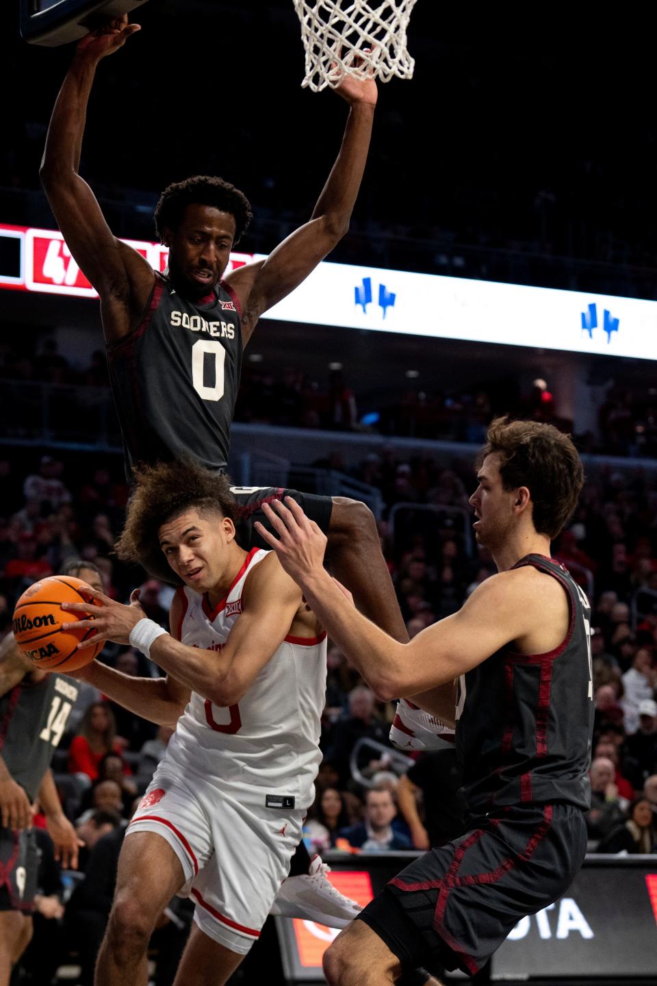 Oklahoma guard Le'Tre Darthard (0) fouls Bearcats guard Dan Skillings Jr. (0) in the second half.  The Bearcats need a bounce-back from Skillings, who was held to one point against Oklahoma Saturday.