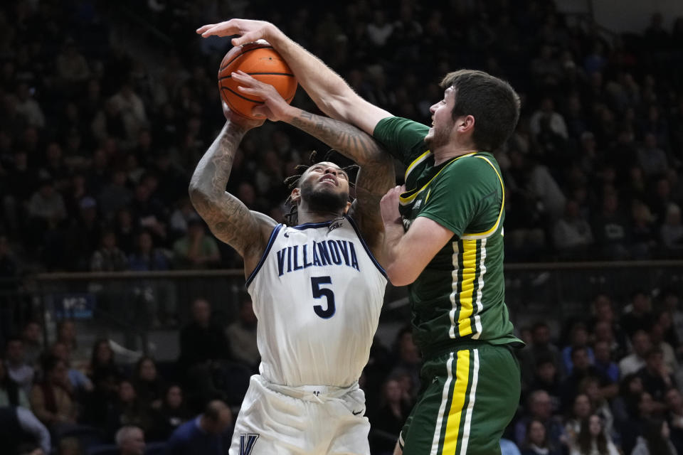 Villanova's Justin Moore, left, tries to get a shot past Le Moyne's Luke Sutherland during the second half of an NCAA college basketball game, Friday, Nov. 10, 2023, in Villanova, Pa. (AP Photo/Matt Slocum)