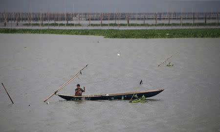 A resident fishes in the calm waters of Laguna de bay in Muntinlupa, Metro Manila, Philippines December 15, 2015, amid heavy current and winds brought by Typhoon Melor in some parts of the country. REUTERS/Erik De Castro