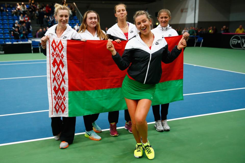 BUDAPEST, HUNGARY - FEBRUARY 07:  Victoria Azarenka of Belarus celebrates with team mates after defeating Heather Watson of Great Britain to win the play off during day four of the Fed Cup/Africa Group One tennis at Syma Event and Congress Centre on February 7, 2015 in Budapest, Hungary.  (Photo by Julian Finney/Getty Images for LTA)