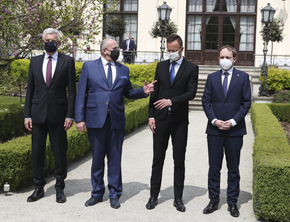 Slovak Foreign Minister Ivan Korcok, left, Polish Foreign Minister Zbigniew Rau, Hungarian Foreign Minister Peter Szijjarto and Czech Republic Foreign Minister Tomas Petricek, right, after meeting the foreign ministers of the Visegrad Group ,V4, in Lodz, Poland, Friday, May 14, 2021. (AP Photo/Czarek Sokolowski)