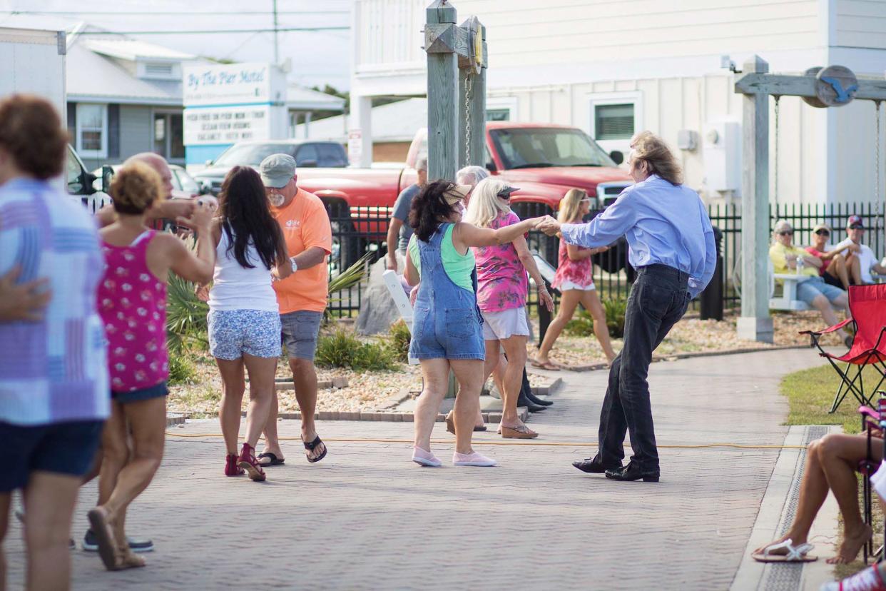 People dance during Kure Beach’s Boogie in the Park concert series in 2019. The free concert series returns this weekend.