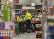 An injured person on a stretcher at the scene of an attack in Milan, Italy, Thursday Oct. 27, 2022. A man armed with a knife stabbed five people inside a shopping center south of Milan on Thursday. (LaPresse via AP)